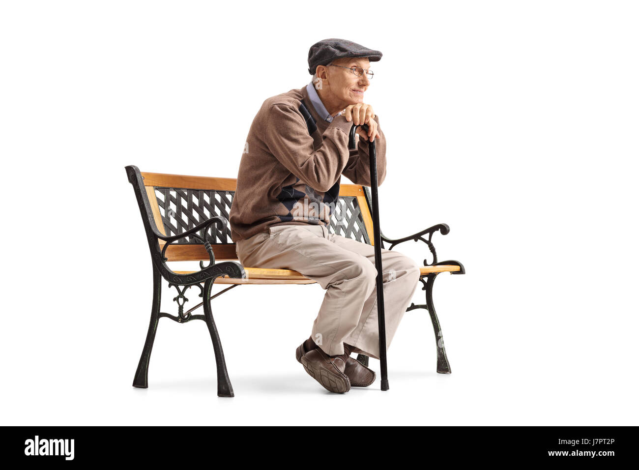 Pensive senior with a walking cane sitting on a bench isolated on white background Stock Photo