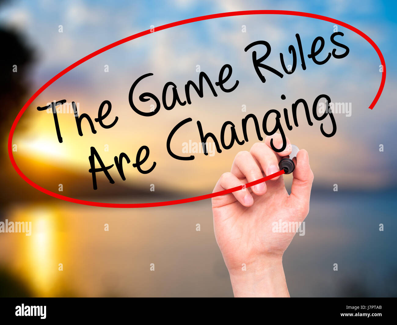 Man Hand writing The Game Rules Are Changing with black marker on ...