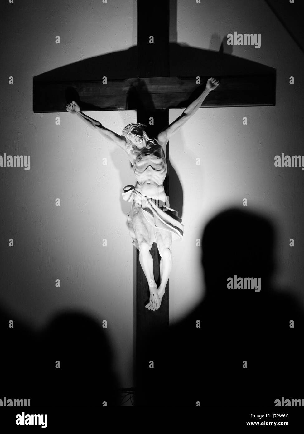 Jesus Christ crucified with men silhouette Stock Photo