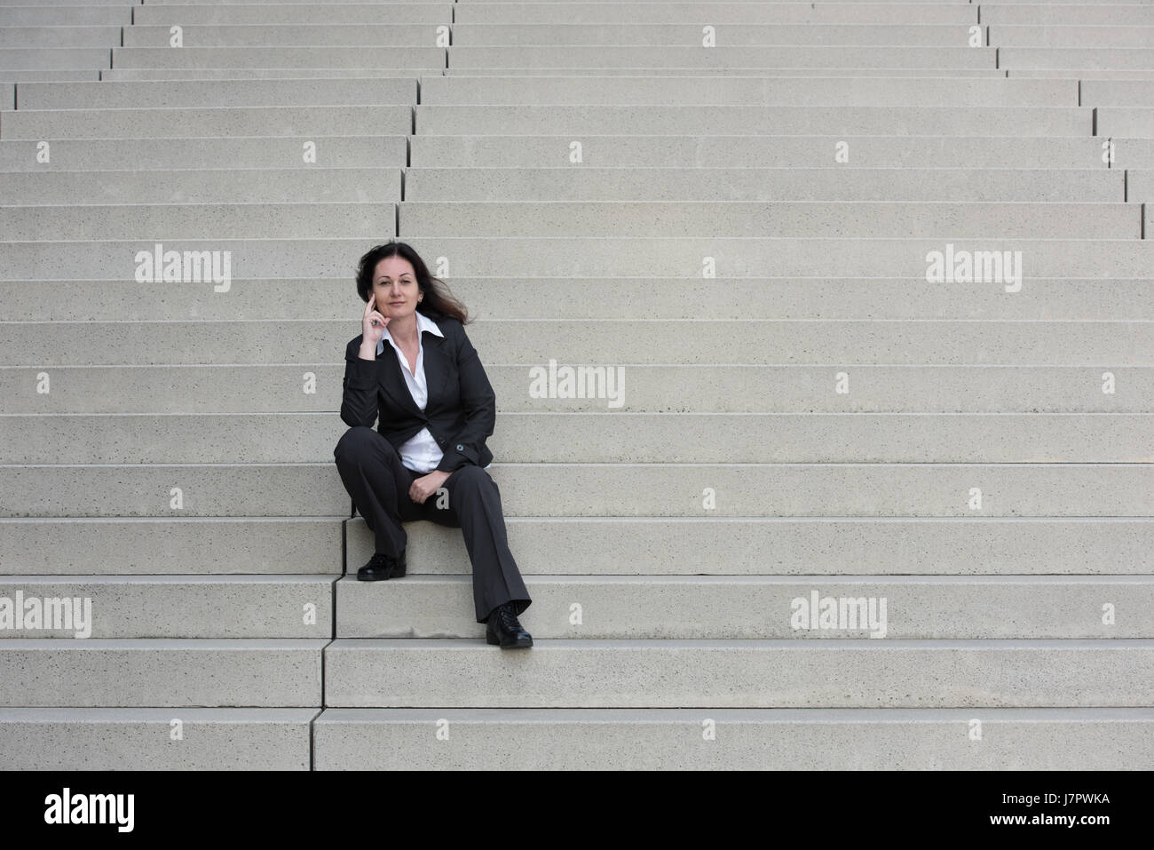 business woman in black business suit on the stairs Stock Photo - Alamy