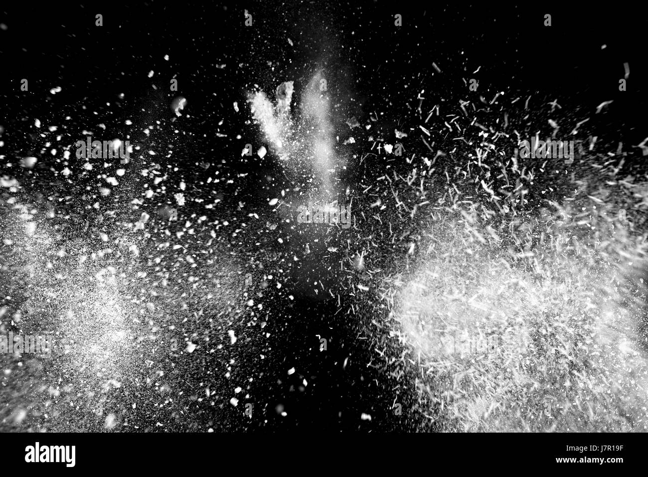 Freeze motion of white powder exploding, isolated on black, dark ...