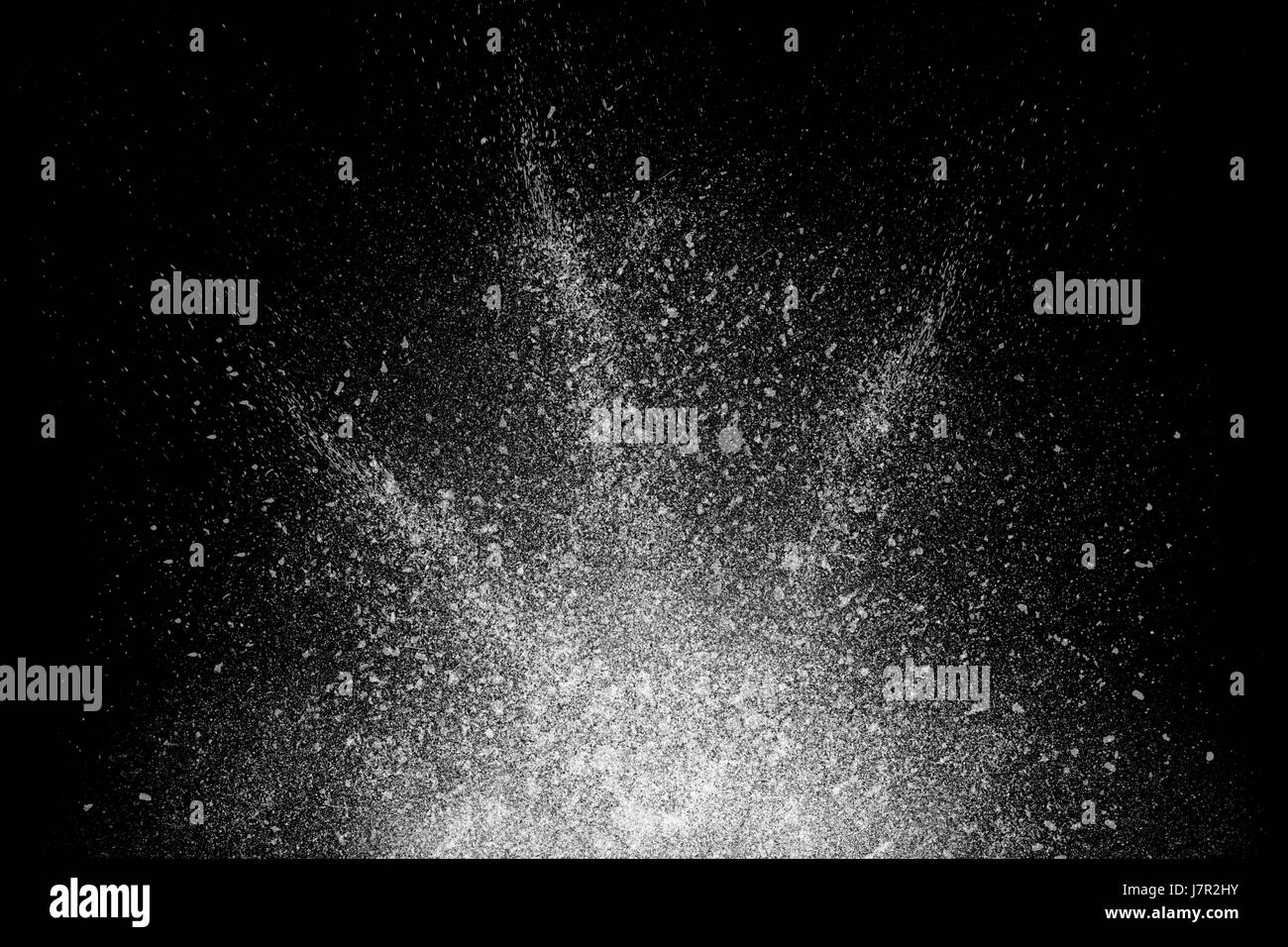 Freeze motion of white powder exploding, isolated on black, dark ...