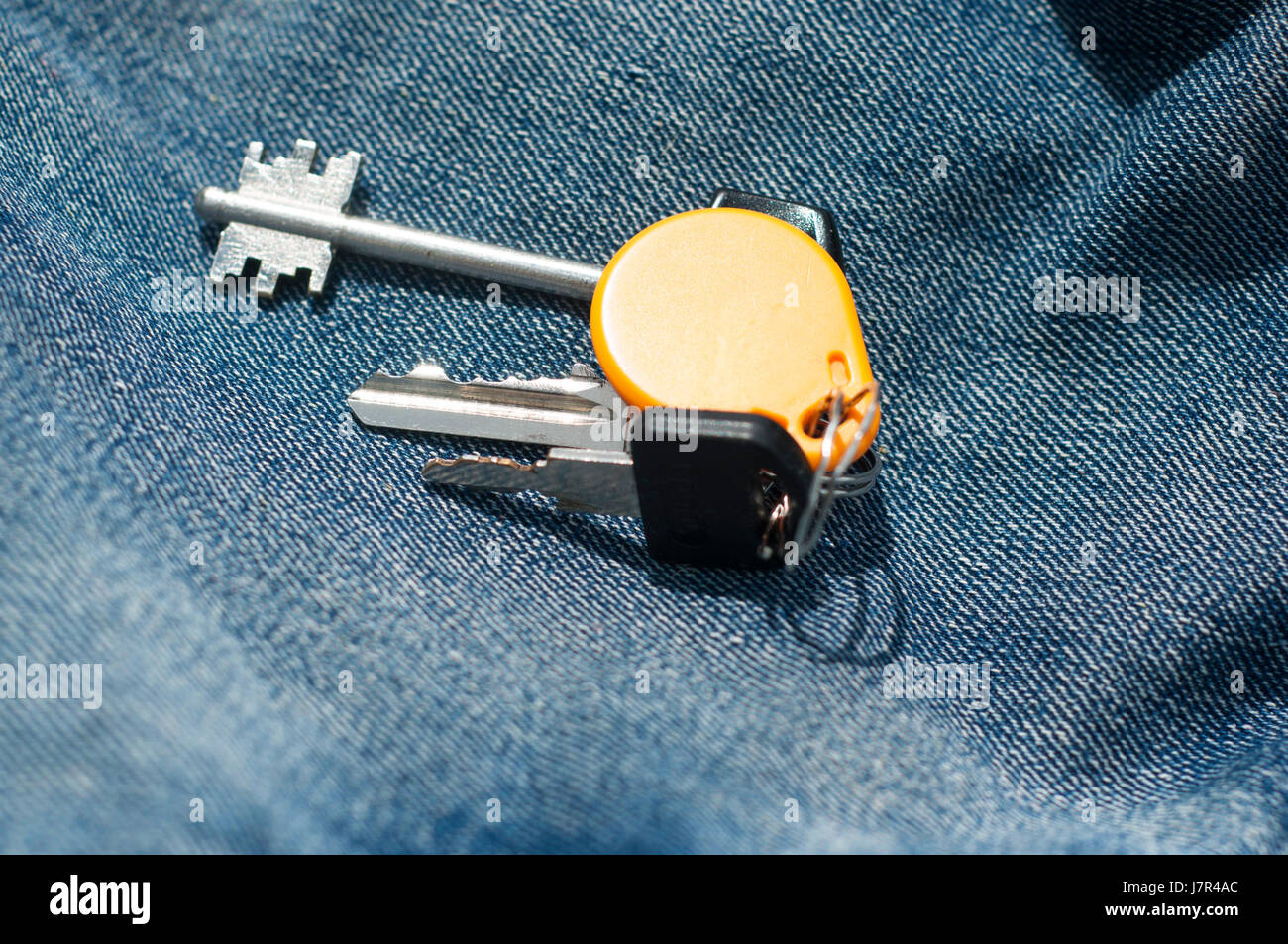 Bunch of keys isolated on a blue jeans texture Stock Photo Alamy