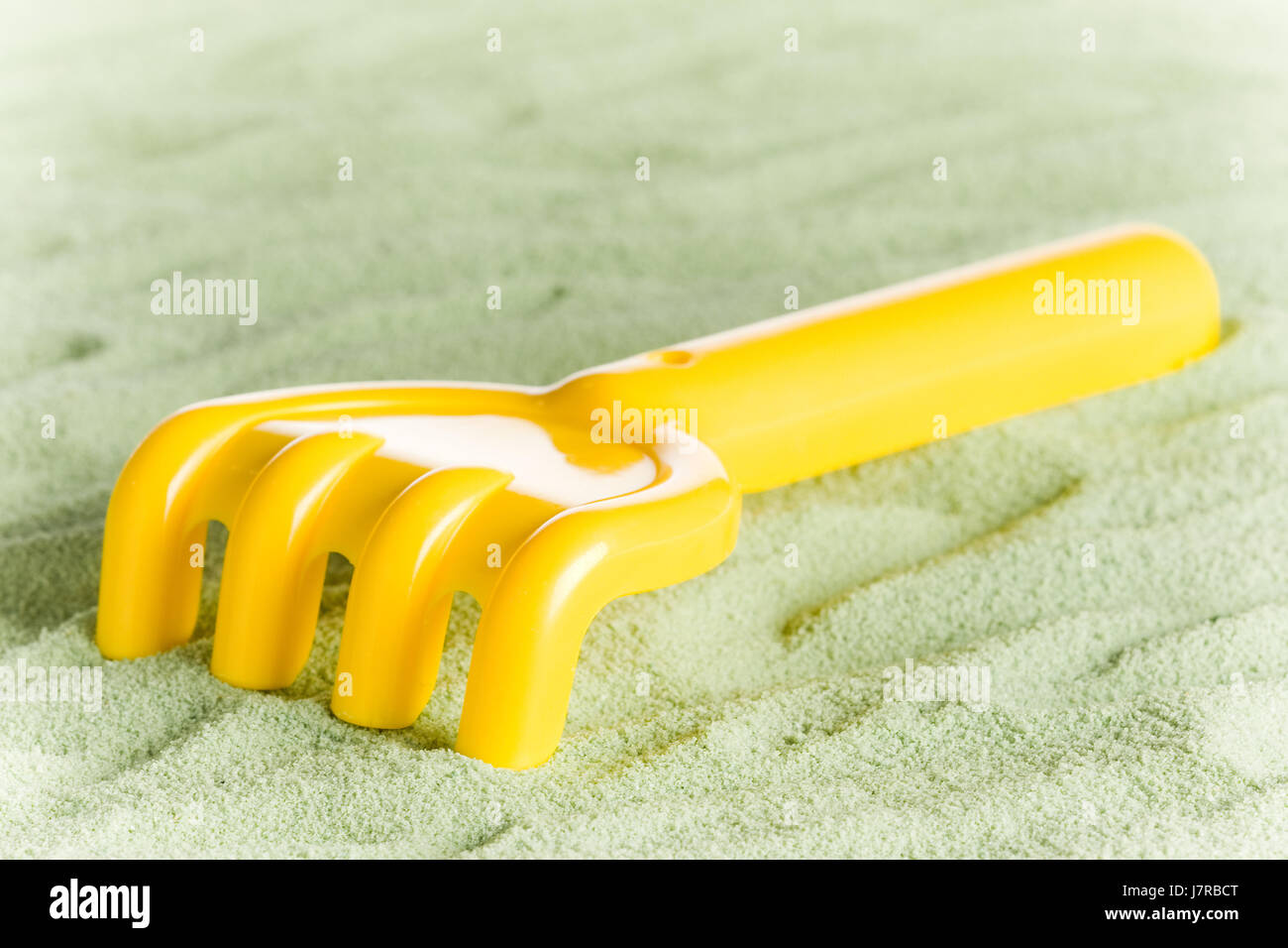 yellow toy rake Stock Photo - Alamy