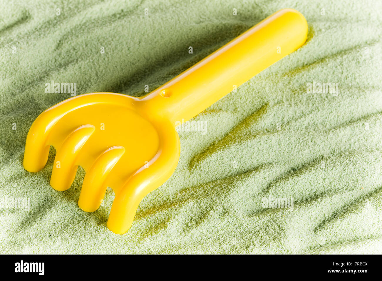 yellow toy rake Stock Photo - Alamy