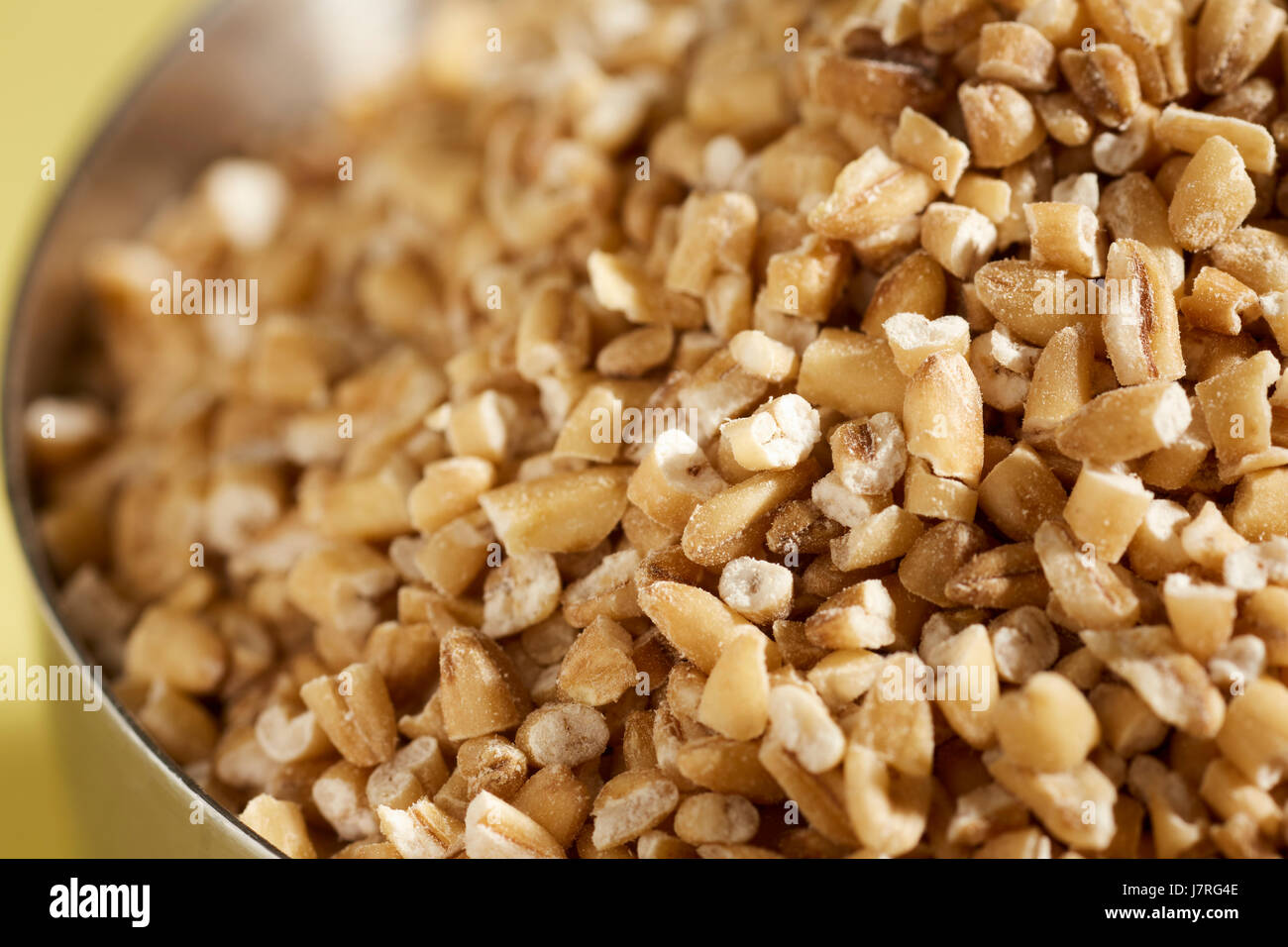 uncooked pinhead oats, also called steel cut oats Stock Photo