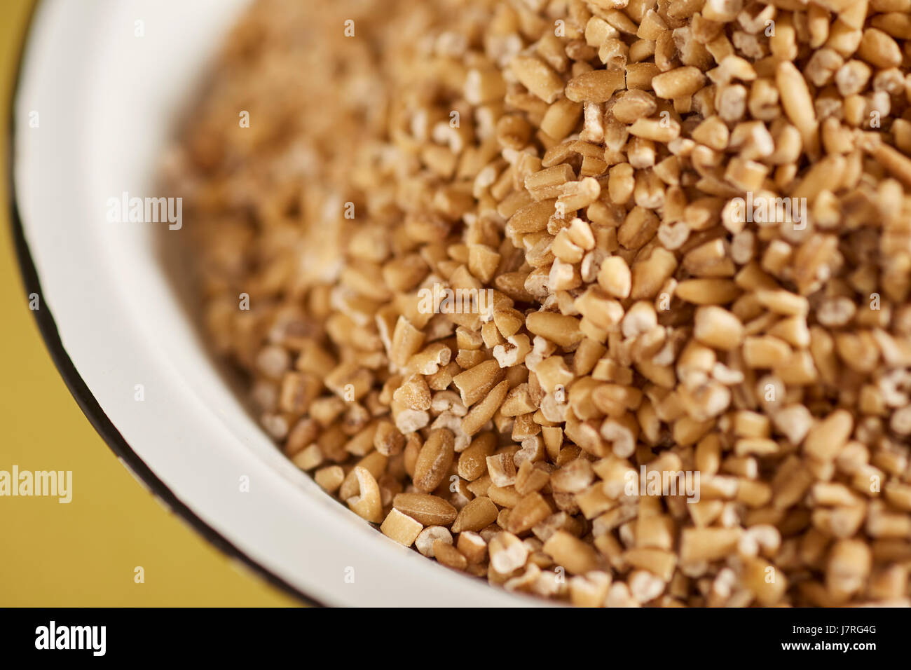 uncooked pinhead oats, also called steel cut oats Stock Photo