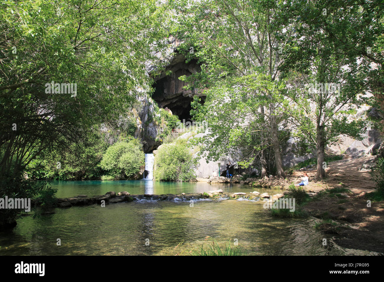 Stream resurgence from limestone cave, Cueva del Gato, Benaojan, Serrania de Ronda, Malaga province, Spain Stock Photo