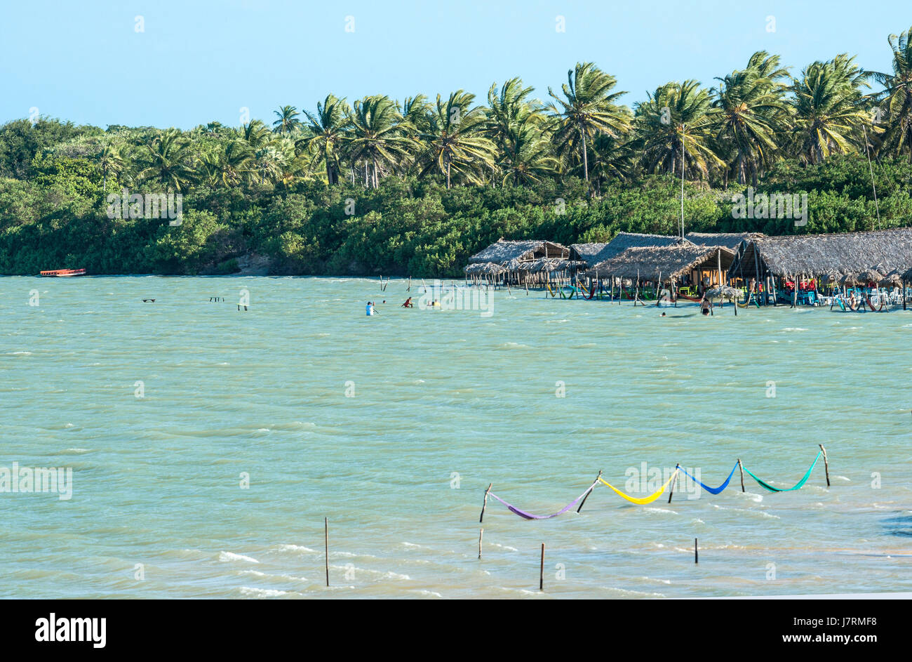 Jericoacoara, Ceara state, Brazil - July 2016: tourists and hammocks are on the beach and Lagoon Tatajuba from above Stock Photo