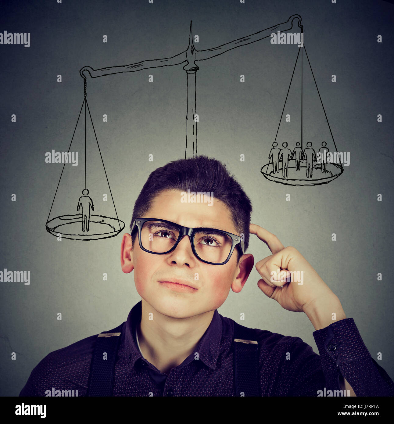 Man making a decision with scale above head and people on a balance. Power, self importance concept. Stock Photo