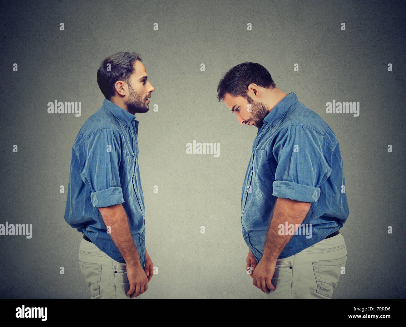Slim guy looking at fat man himself. Diet choice right nutrition healthy lifestyle concept Stock Photo