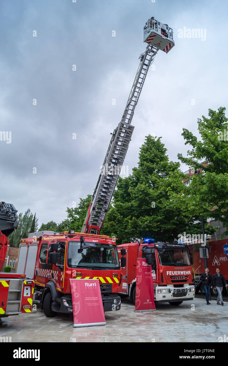 Journalists riding on a Magirus M68L turntable ladder at a fire service