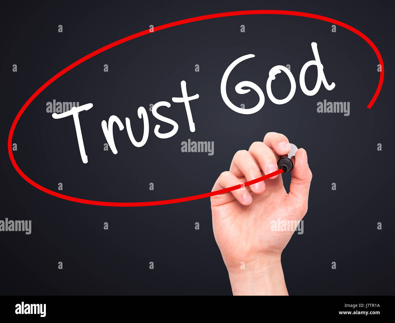 Man Hand writing Trust God  with black marker on visual screen. Isolated on black. Business, technology, internet concept. Stock Photo Stock Photo