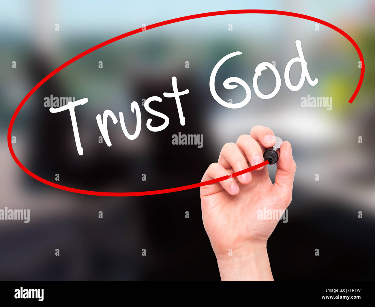 Man Hand writing Trust God  with black marker on visual screen. Isolated on office. Business, technology, internet concept. Stock Photo Stock Photo