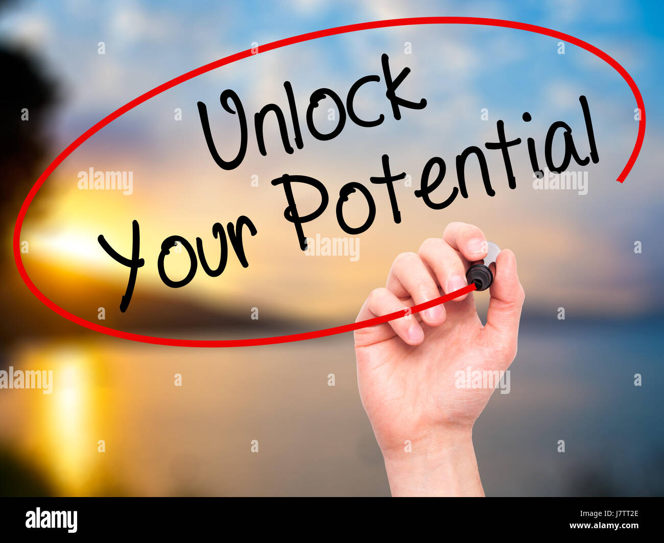 Man Hand writing Unlock Your Potential with black marker on visual ...