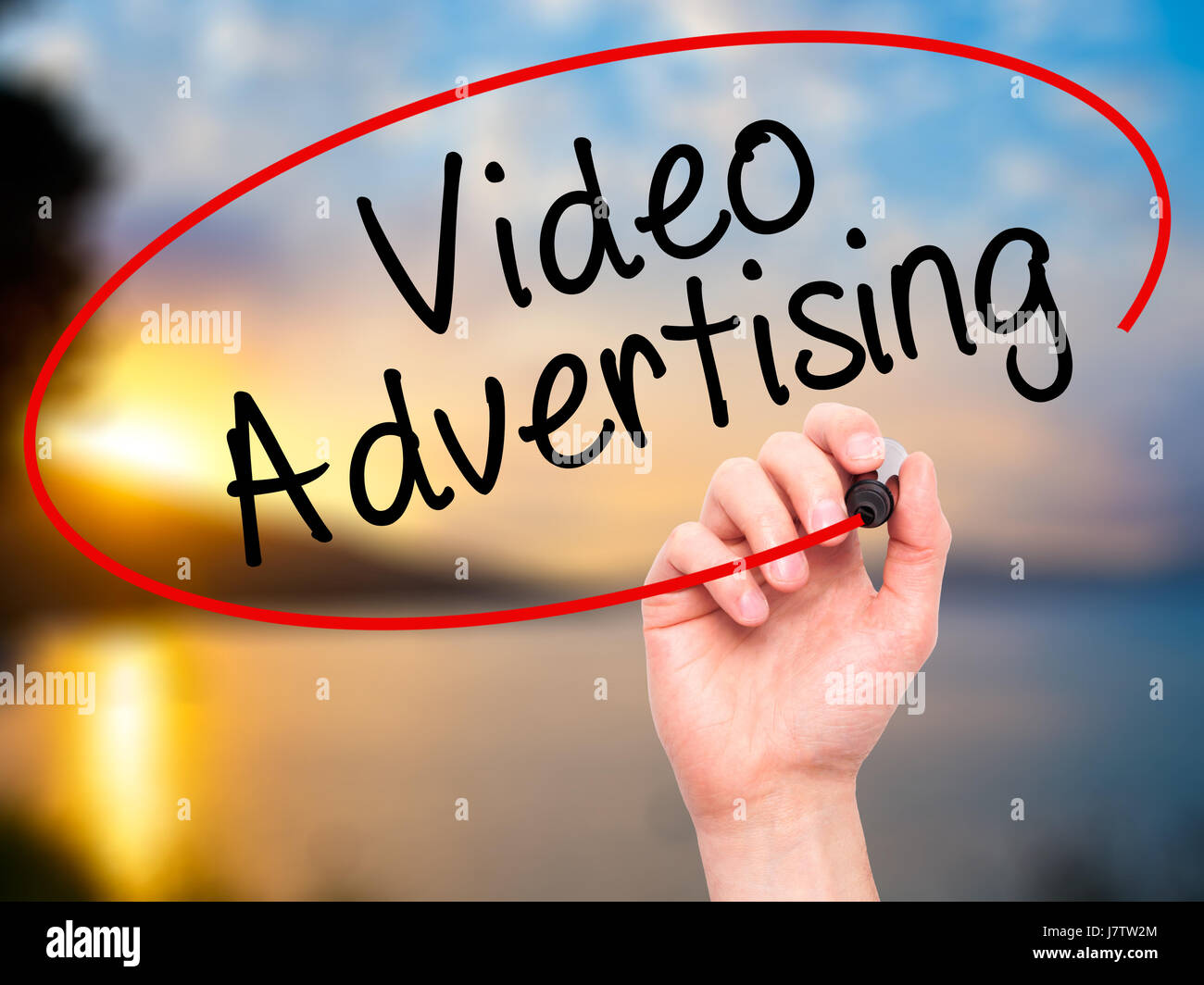 Man Hand writing Video Advertising with black marker on visual screen ...