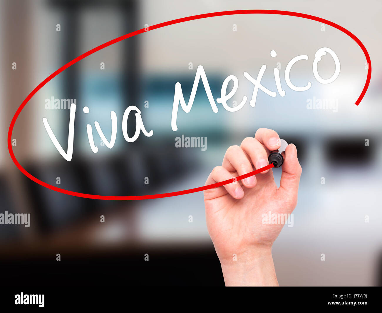 Man Hand writing Viva Mexico with black marker on visual screen. Isolated on office. Business, technology, internet concept. Stock Photo Stock Photo
