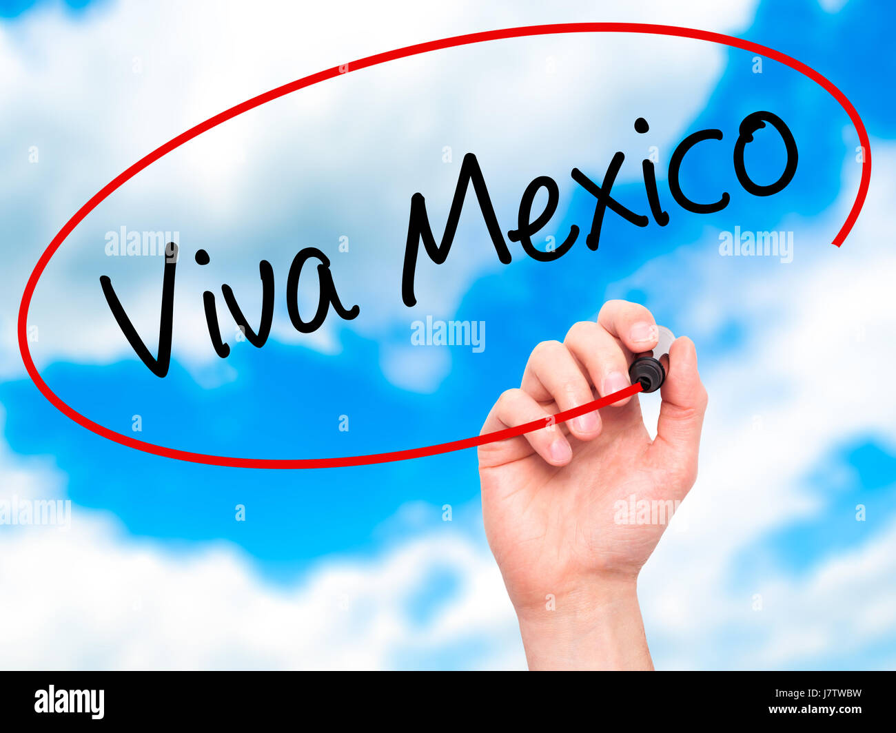 Man Hand writing Viva Mexico with black marker on visual screen. Isolated on sky. Business, technology, internet concept. Stock Photo Stock Photo