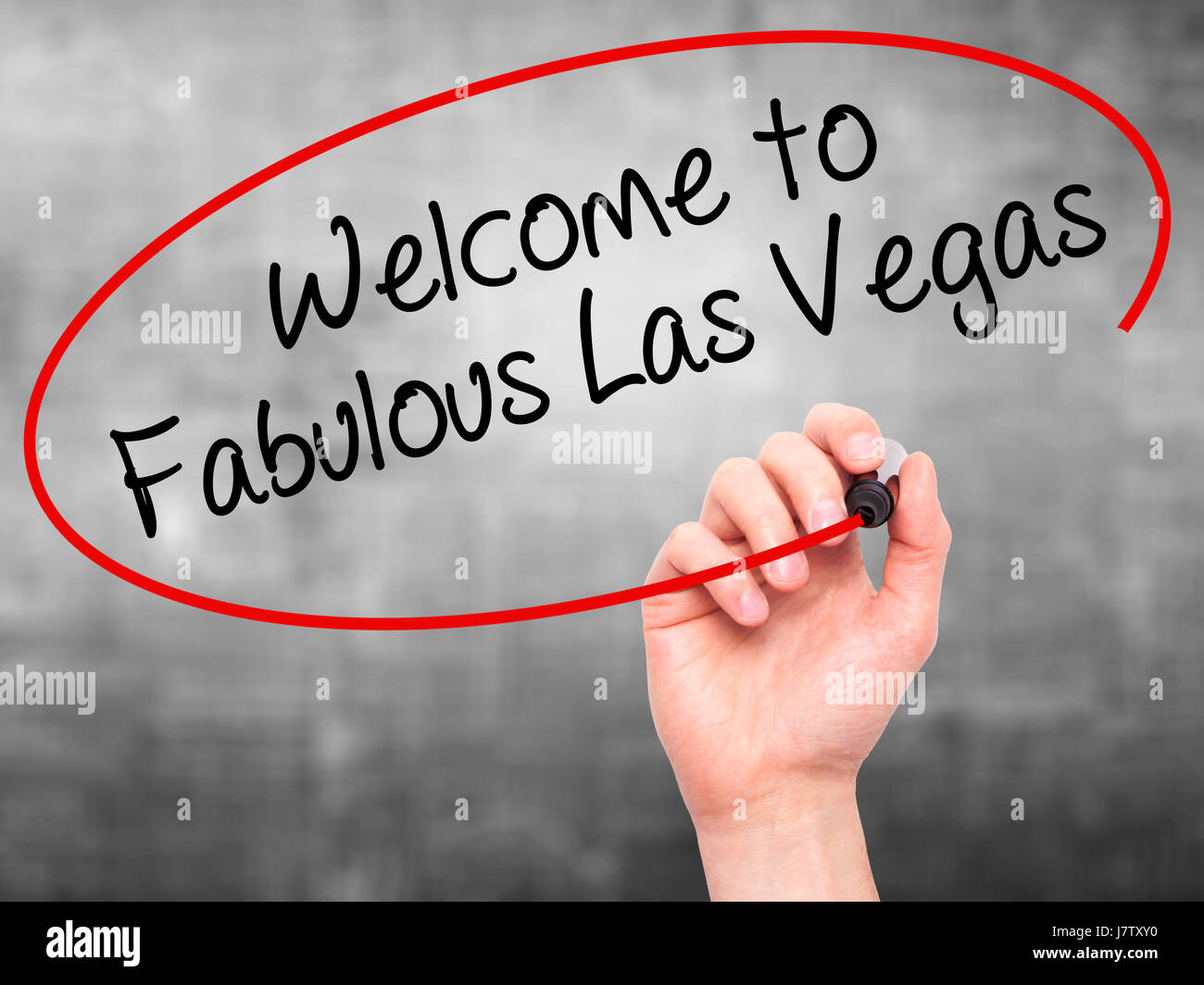Man Hand writing to Fabulous Las Vegas with black marker on