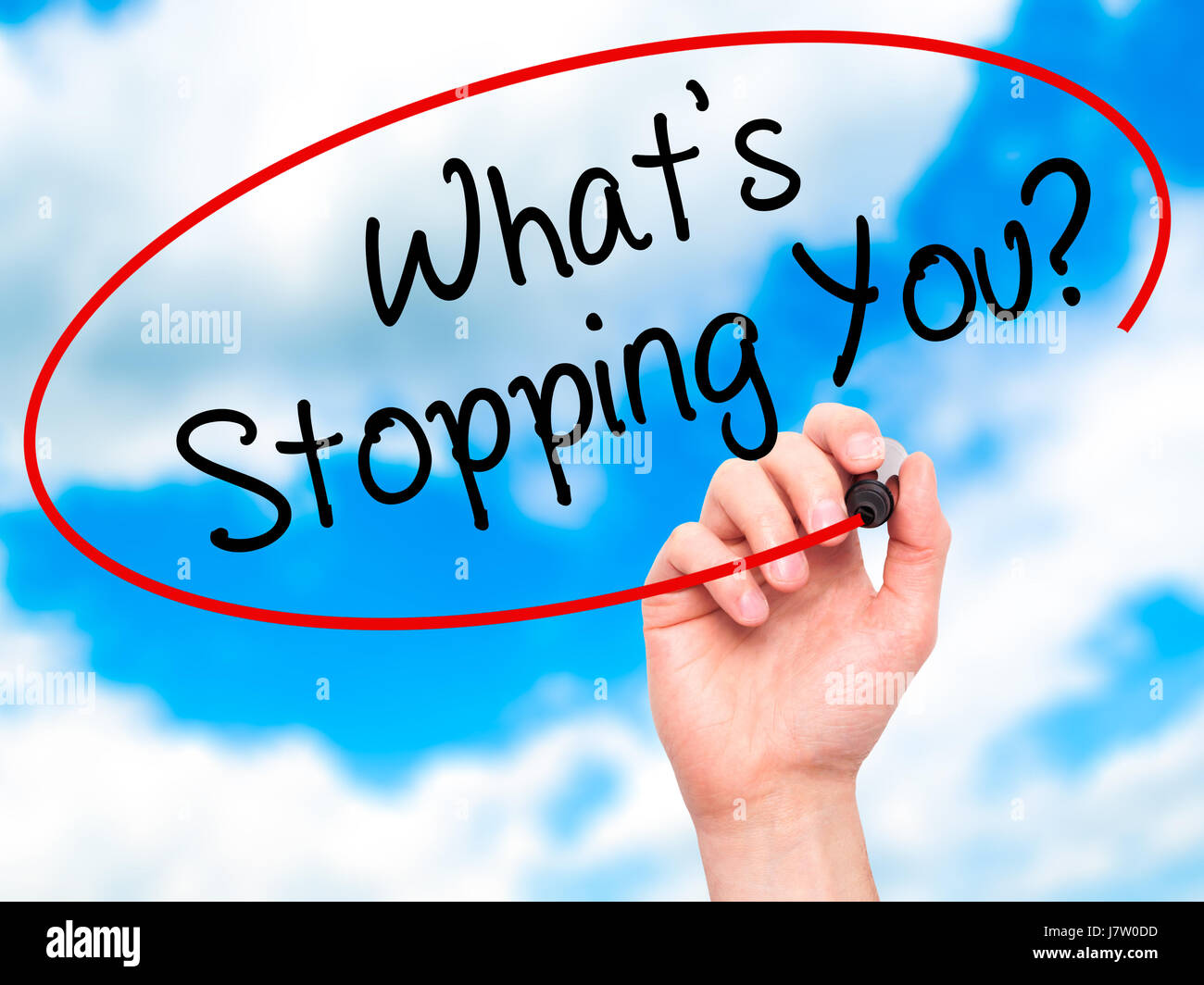 Man Hand writing What's Stopping You?  with black marker on visual screen. Isolated on sky. Business, technology, internet concept. Stock Photo Stock Photo