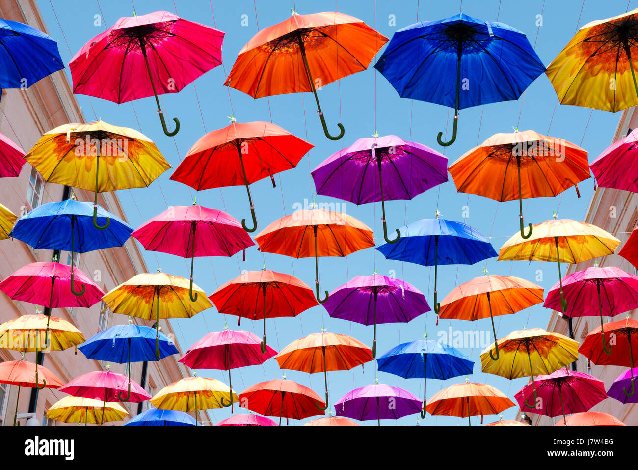 Bath, Somerset, UK. Colourful umbrellas suspended above the street as part of an art festival. Stock Photo