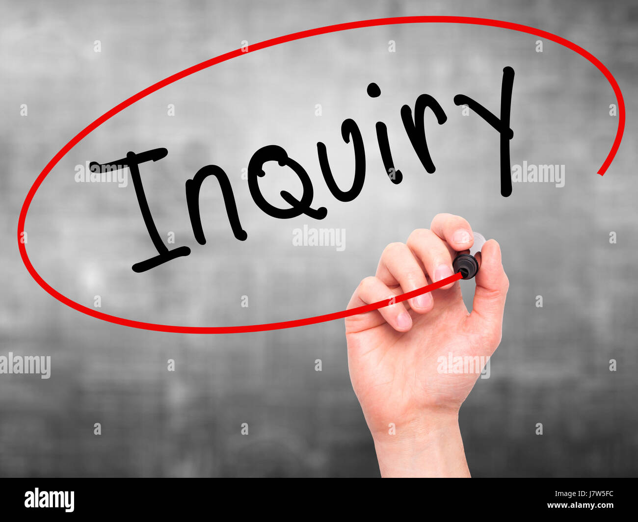 Man Hand writing Inquiry with marker on transparent wipe board ...