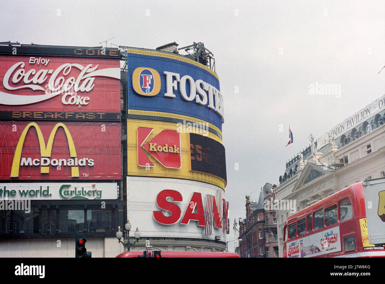 This 1988 photograph of Piccadilly Circus, London, showcases the iconic public space known for its bustling atmosphere and bright advertisements. The image reflects the vibrant urban culture and energy of London in the late 20th century. Stock Photo
