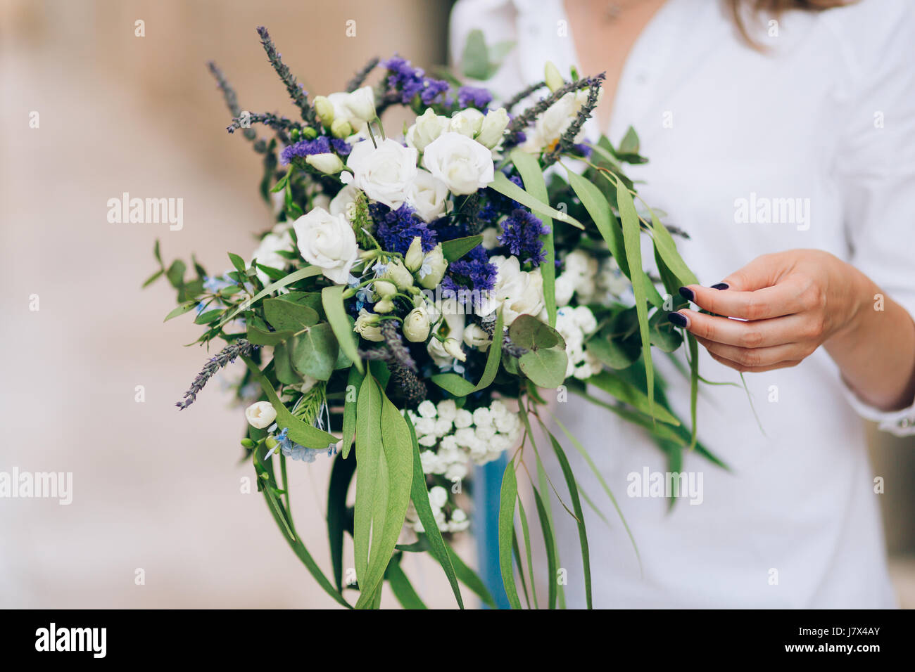 Wedding bridal bouquet of roses, lisianthus, lavender, Gypsophila, Verdure Italian in the hands of the bride. Wedding in Croatia, Dubrovnik. Stock Photo