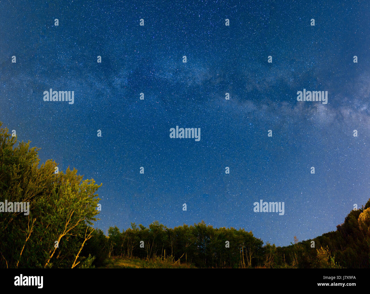 The starry sky and the Milky Way over the mountains and the fore Stock ...