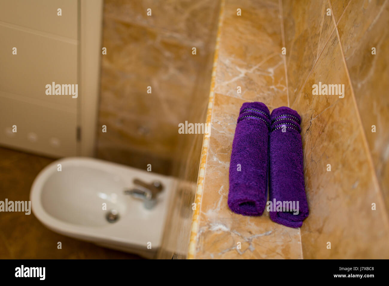 Purple towels in the bathroom in rolls Stock Photo - Alamy