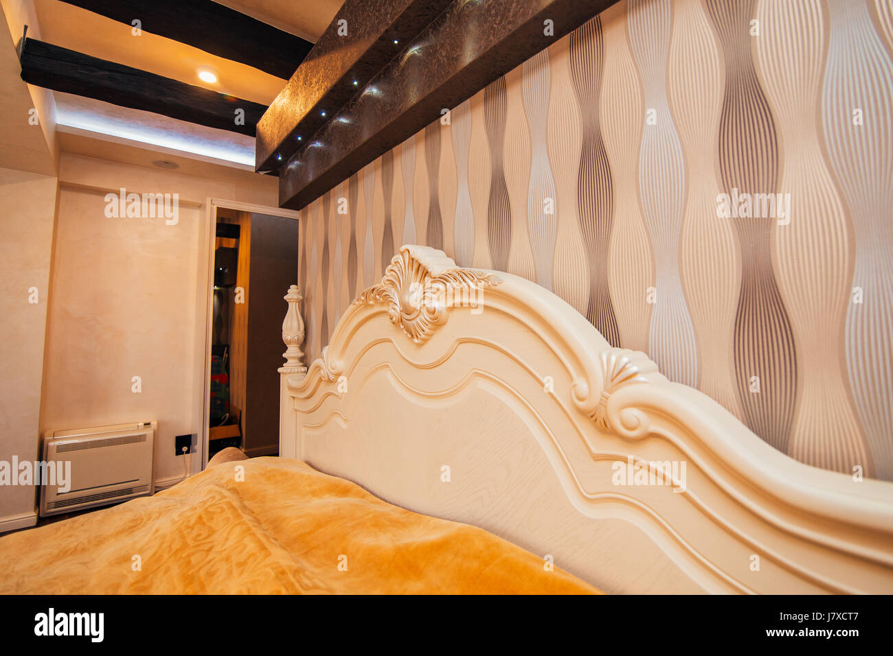 Carved wooden white bed. Design interior of apartment Stock Photo Alamy