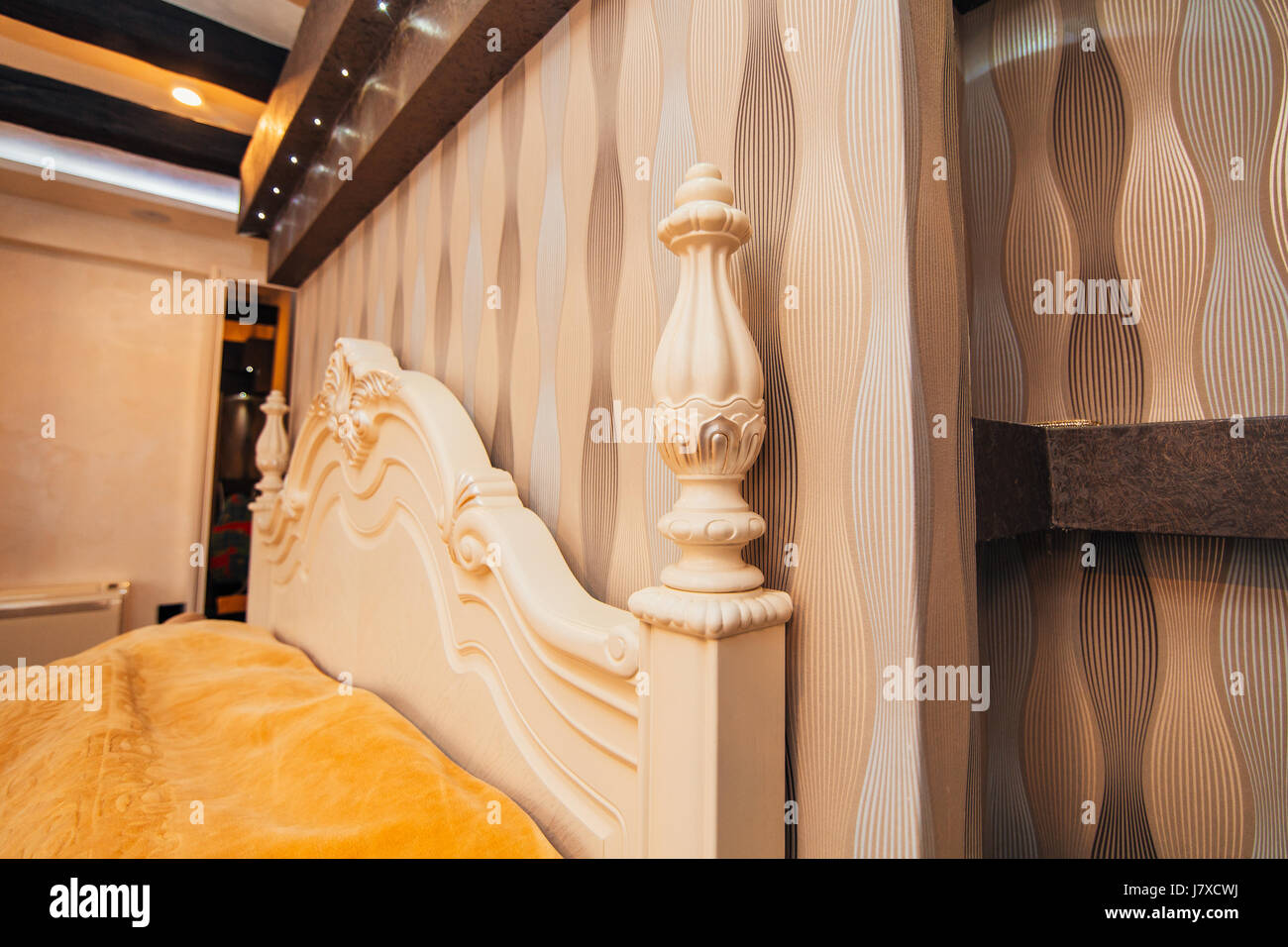 Carved wooden white bed. Design interior of apartment Stock Photo Alamy