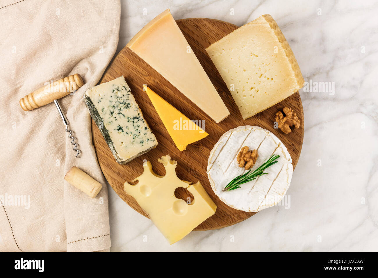 Selection of cheeses with corkscrew, cork, and copyspace Stock Photo