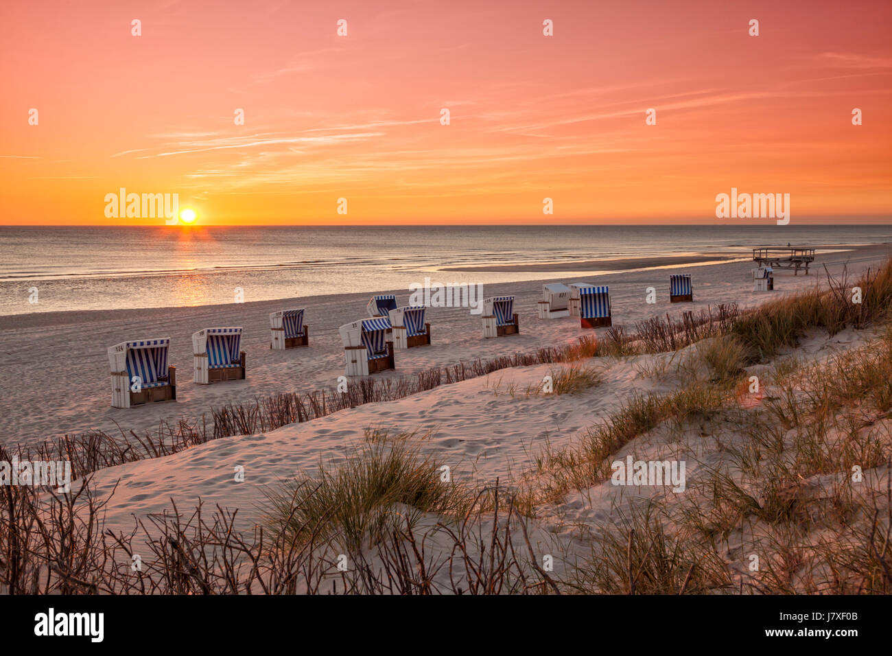 Beach chairs at North Sea beach of Hörnum, Sylt, in sunset Stock Photo