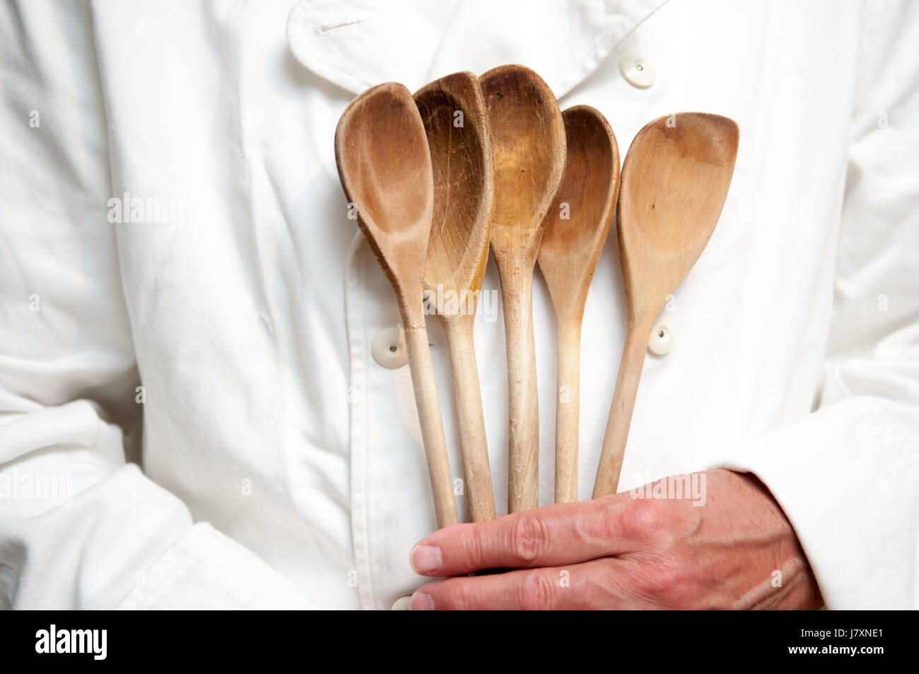 Chef holds cokking and kitchen utensils Stock Photo