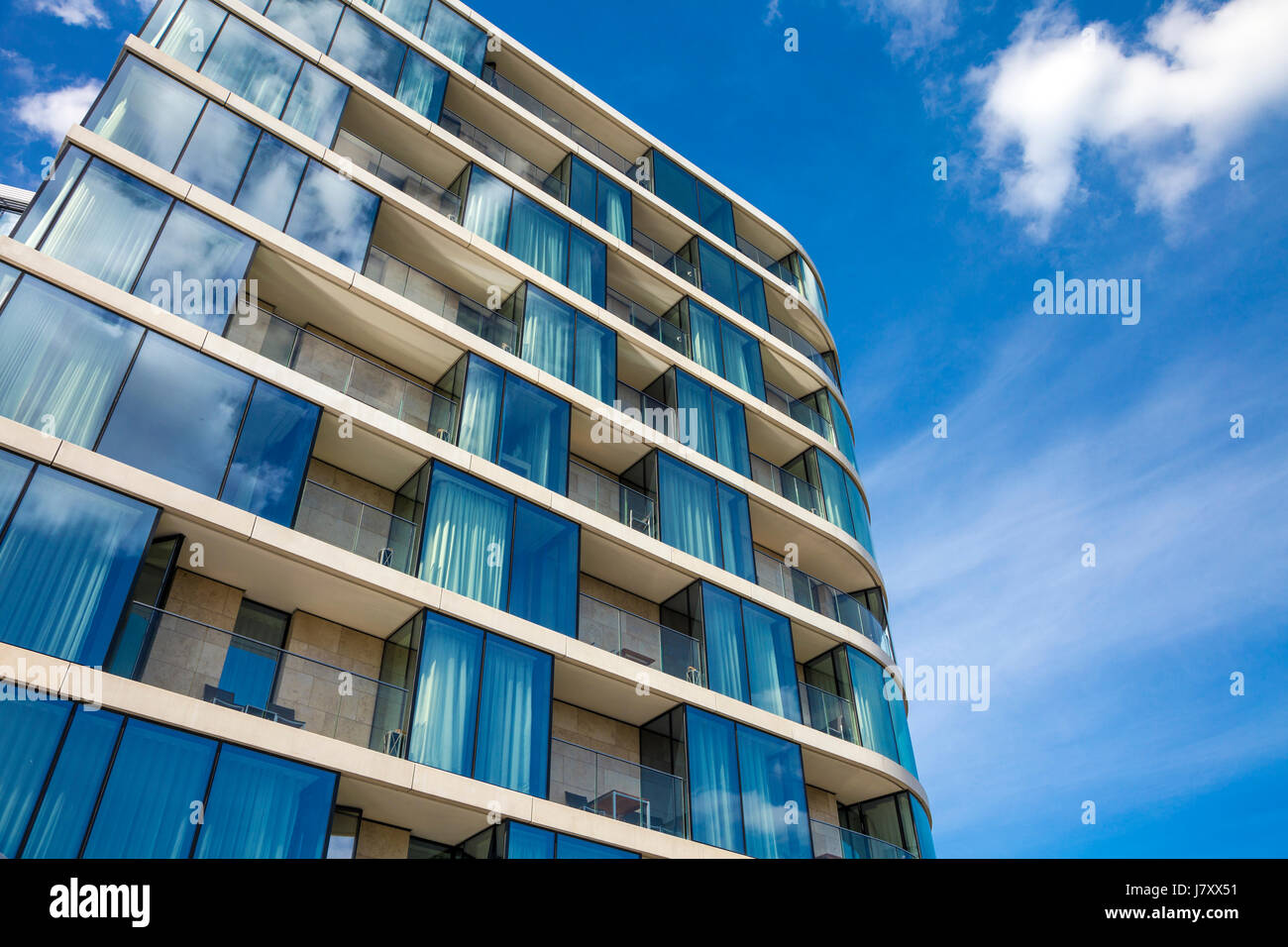 Modern residential apartment building with balconies (Cheval Three Quays Hotel, London, UK) Stock Photo