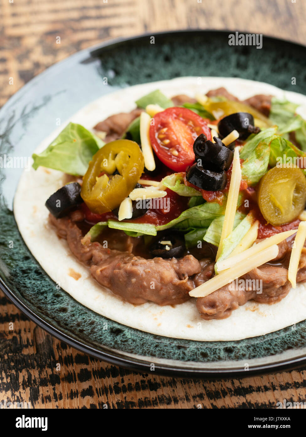 ingredients flour tortillas, refried beans, tomato salsa, lettuce, vegan cheese shredded, black