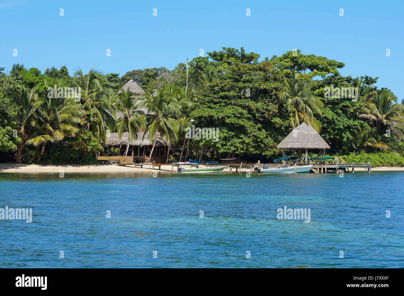Coastline with an eco resort and lush tropical vegetation, Bocas del Toro, Caribbean sea, Panama, Central America Stock Photo