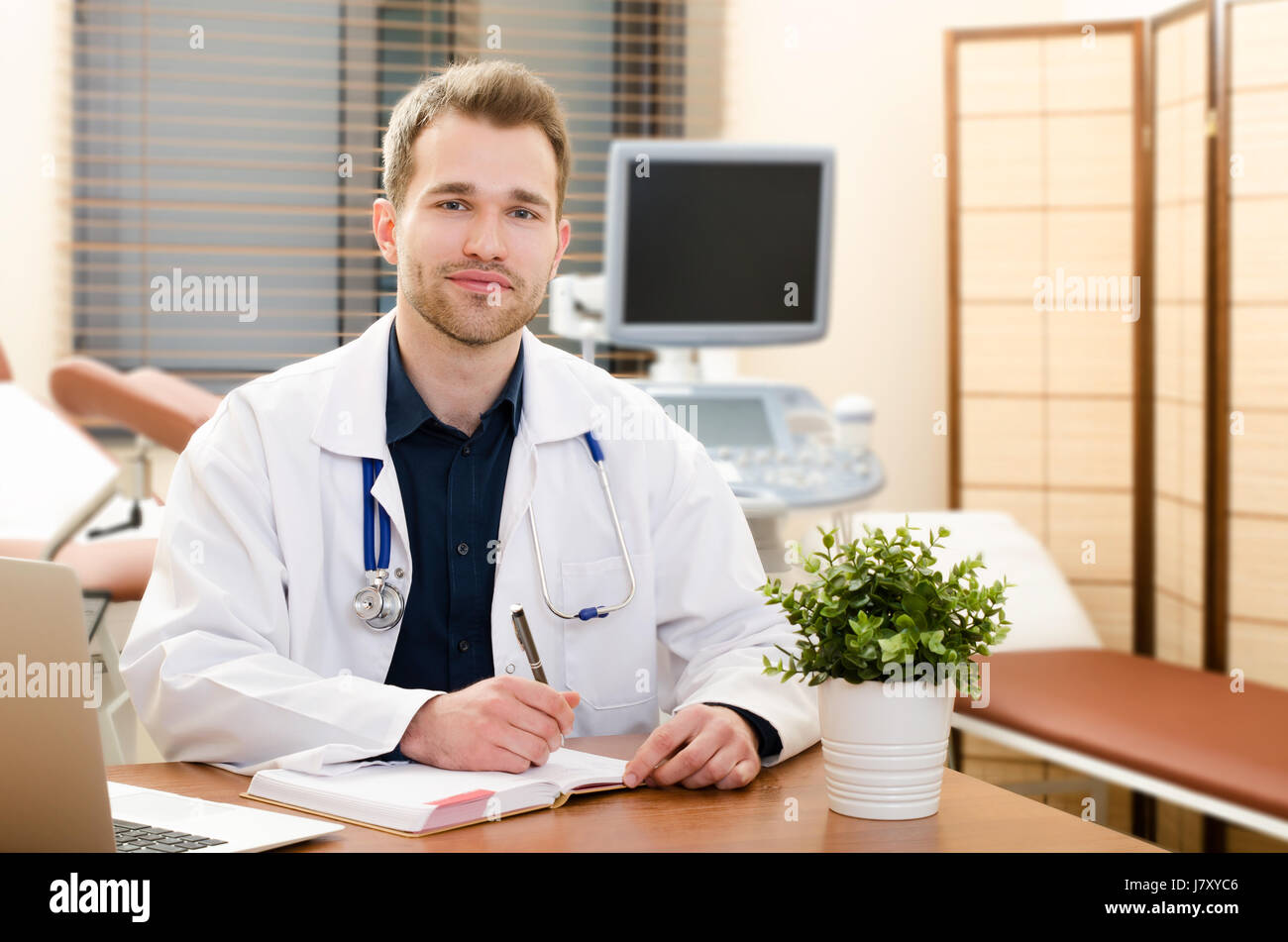 Doctor gynecologist working in office. Ultrasound in background. doctor office work ultrasound medical desk computer front concept Stock Photo