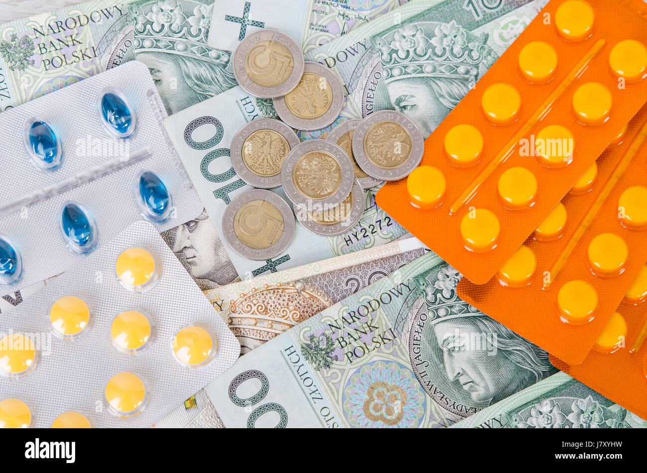 Pills and polish zloty bills. medicine pills health cost polish money zloty pln concept Stock Photo