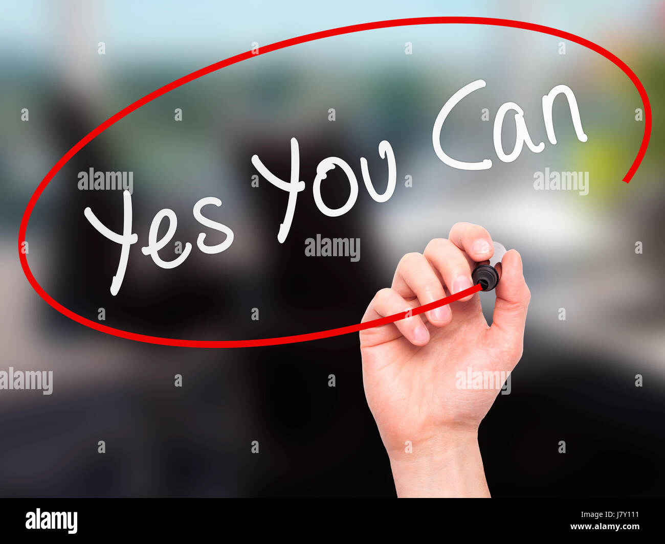 Man Hand writing Yes You Can with marker on transparent wipe board ...
