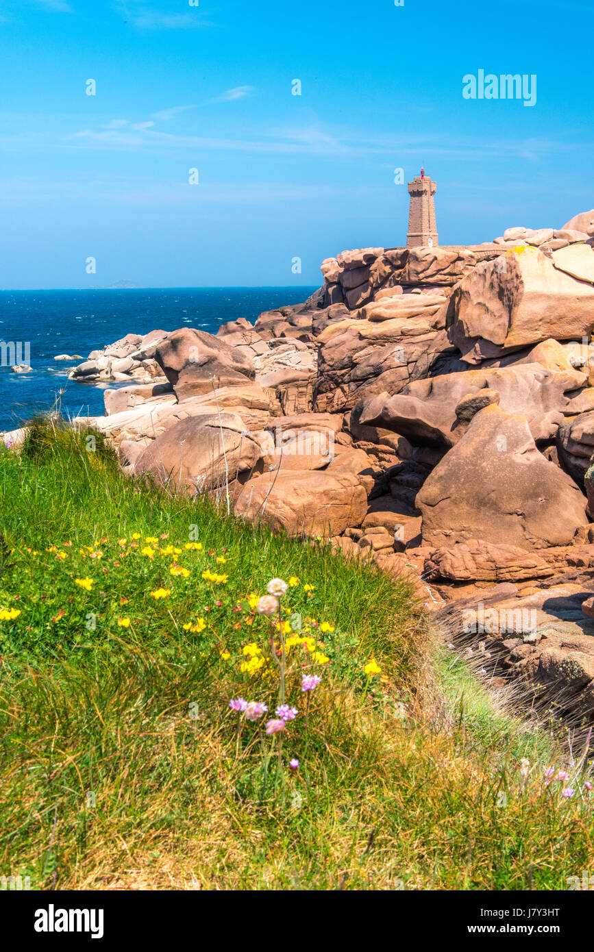 Ploumanach lighthouse, boulders on the Cote de Granit Rose, Pink Granite Coast, Brittany, France, view from Sentier des Douaniers path Stock Photo