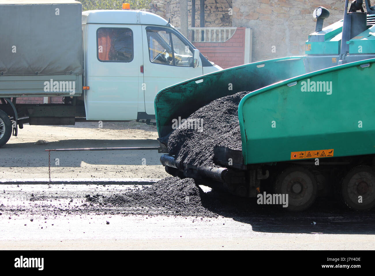 Snorting Asphalt Car for asphalt road with crumb of asphalt in a scoop Stock Photo - Alamy