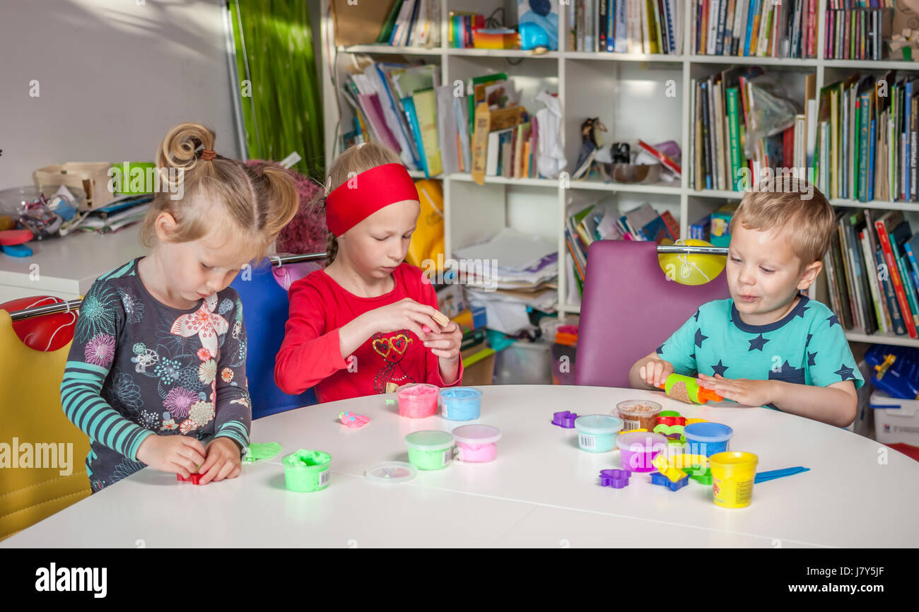 cute little kids playing with plasticine Stock Photo