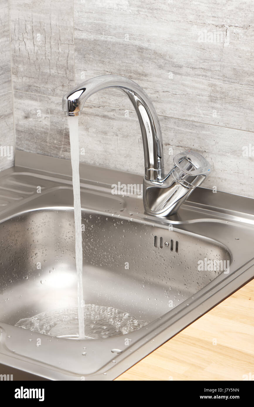 Close up of kitchen sink with running tap water Stock Photo Alamy
