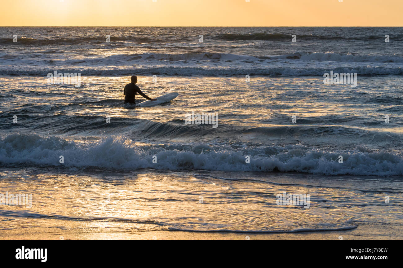 Florida surfer heading out into the waves for a sunrise surf session in Ponte Vedra Beach. (USA) Stock Photo
