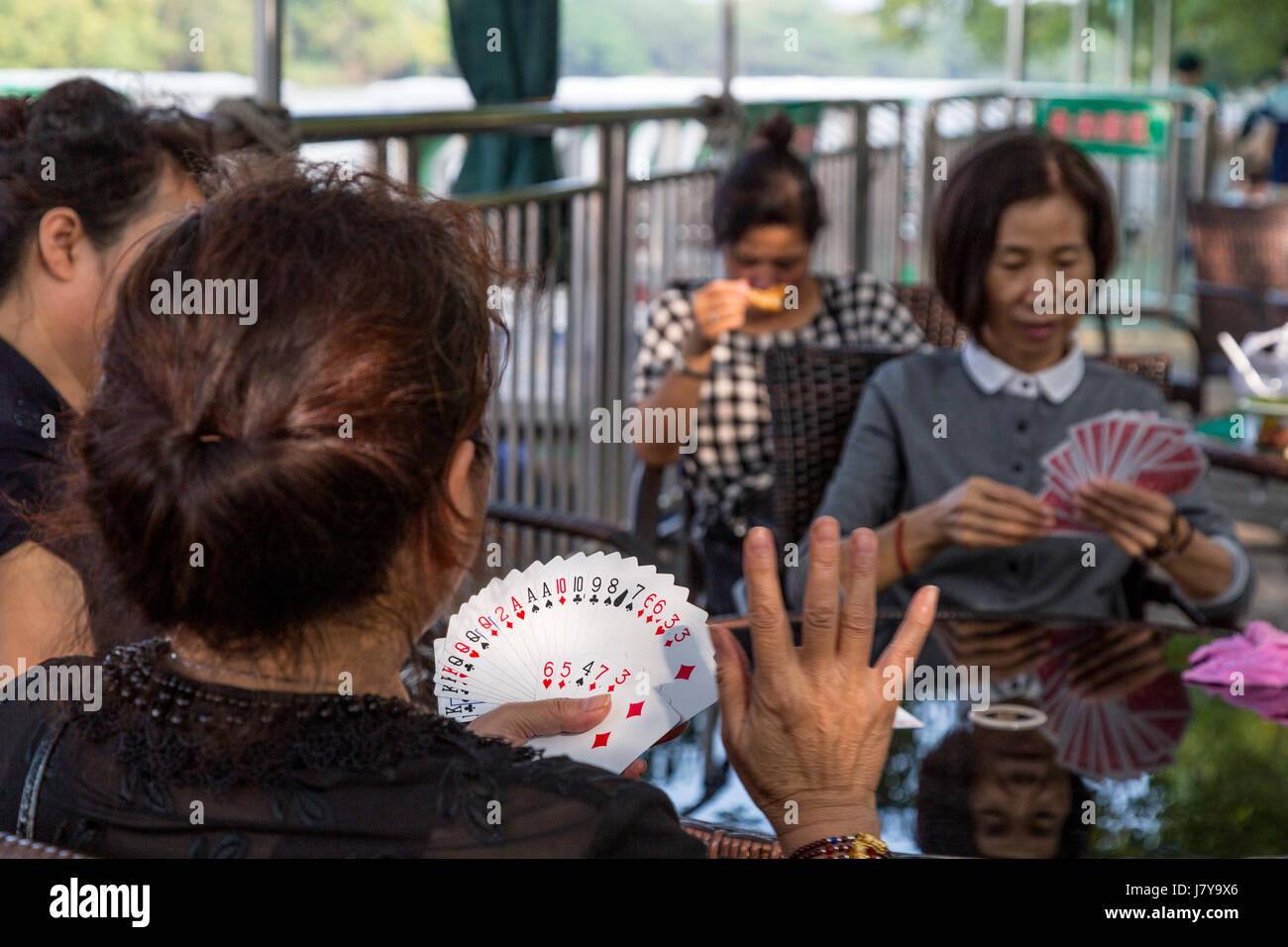 Wenzhou, Zhejiang, China.  Jiangxin Island, Women Playing Cards. Stock Photo