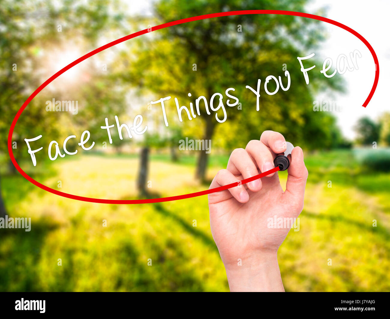 Man Hand writing Face the Things you Fear with black marker on visual ...