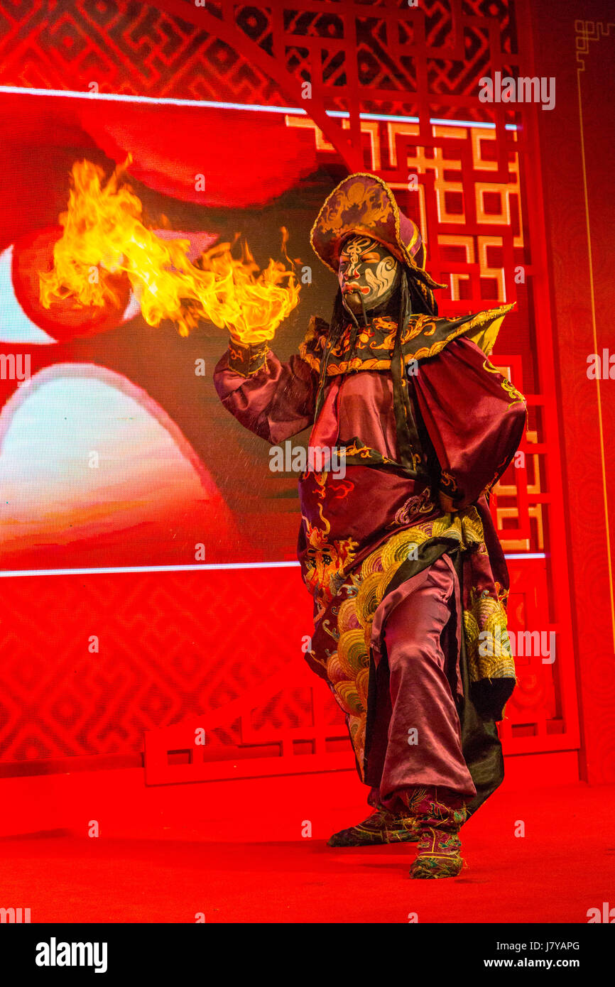 Wenzhou, Zhejiang, China.  Chinese Opera Performer and Face Changing Demonstration.  Fire Emphasizes the Anger of the Character. Stock Photo