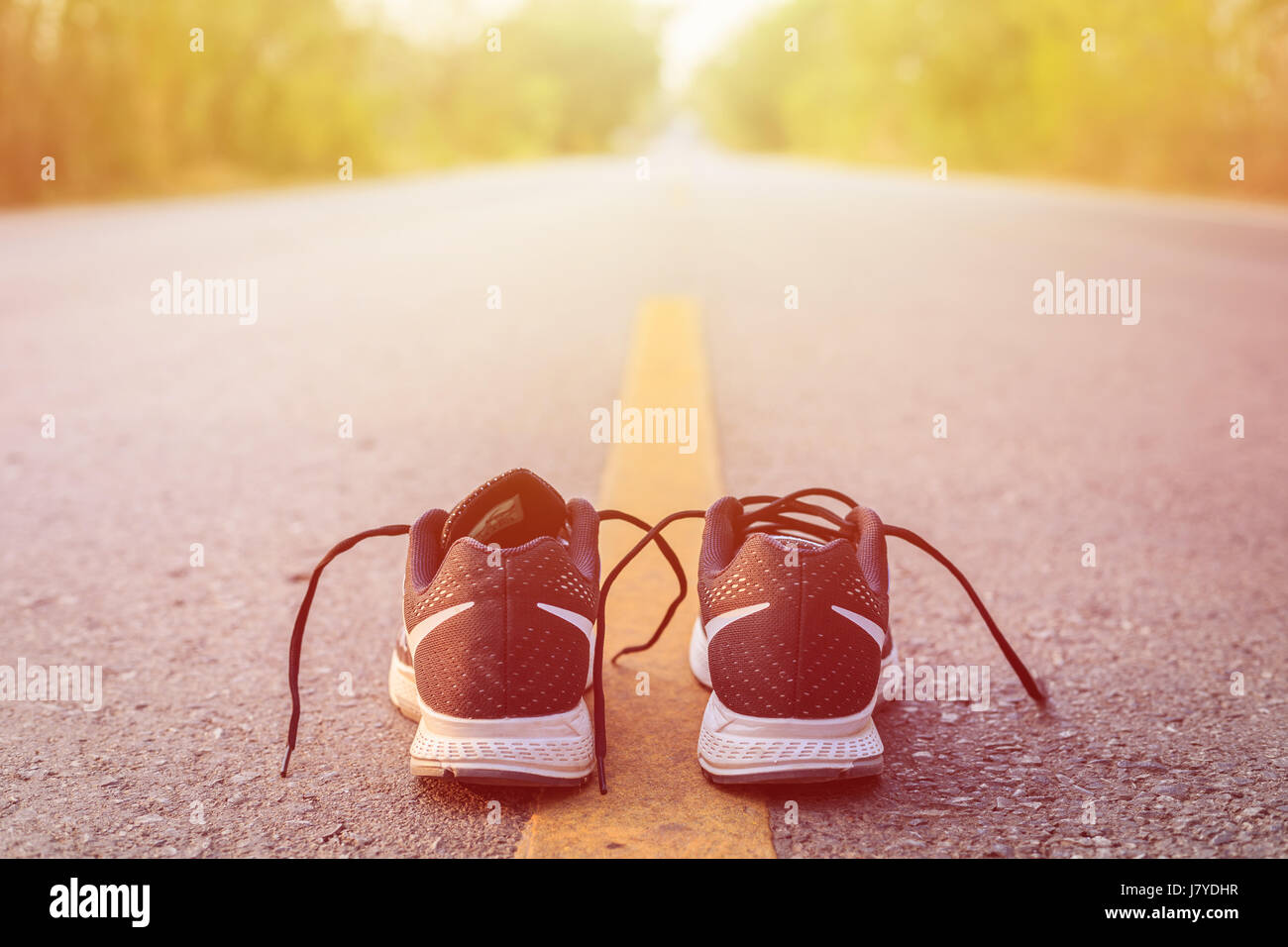 Close up new black running shoes on asphalt road in morning time Stock Photo Alamy